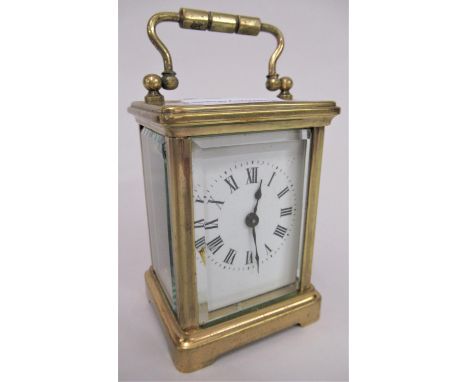 Small brass cased carriage clock with enamel dial and Roman numerals and single train movement 