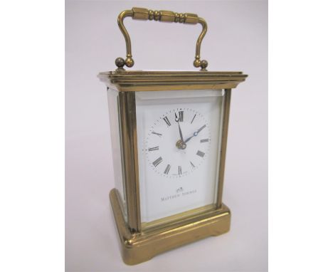 Modern brass cased carriage clock, the enamel dial with Roman numerals, signed Mathew Norman, signed again to the back plate 