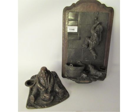 Early 20th Century dark patinated spelter wall mounted matchstriker in the form of a figure climbing a wall, together with a 