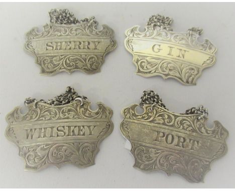 Set of four Victorian silver decanter labels for whisky, gin,port and sherry, makers mark G.U.55mm x 33mm 