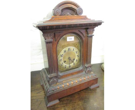 Late Victorian walnut bracket clock, the arched dial with Arabic numerals with a two train movement striking on gongs, togeth