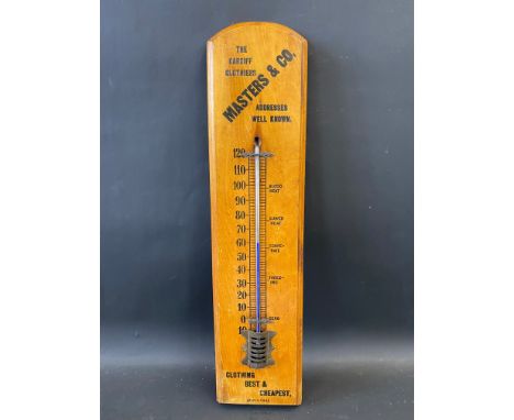 A wooden thermometer bearing advertising for Masters &amp; Co. The Cardiff Clothiers, 5 x 21".