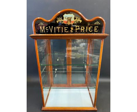 A McVitie &amp; Price counter top dispensing cabinet with pictorial glass pediment and two rear opening doors, 22" w x 35" h 