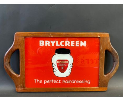 A barber's wooden framed hand held mirror with inset mirror and coloured glass panel both advertising Brycreem.