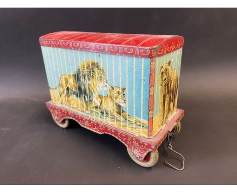 A Chad Valley for Jacob's Biscuits tin in the shape of a circus cage trailer containing wild animals.