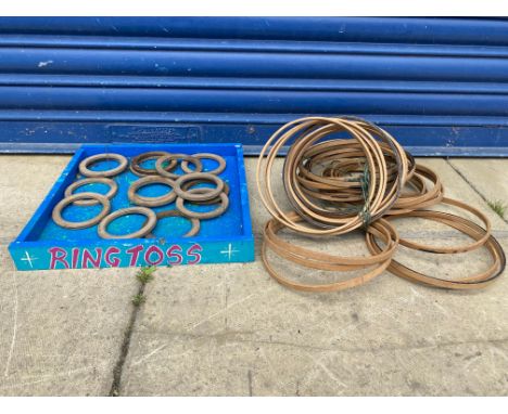 A painted fairground ring toss with wooden hooplas.