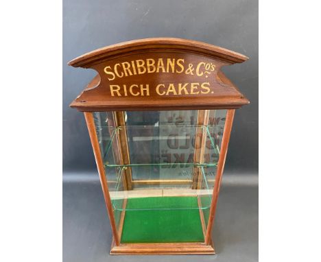 A mahogany counter top dispensing cabinet, with single rear opening door, two glass shelves and a pediment bearing lettering 