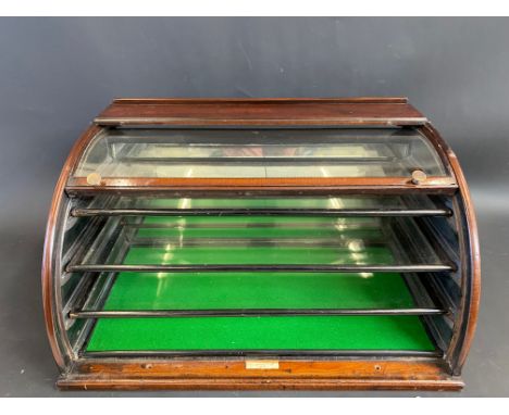 A rare Maw &amp; Son mahogany counter top display cabinet with lift up curved glass front, revealing three pull-out glass she