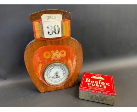 An OXO wall hanging bottle-shaped wooden combined calendar and barometer, plus a Beefex Cubes tin.