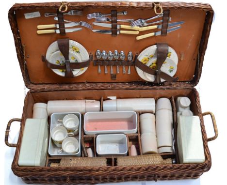 A 1950/60s Brexton 7997 Picnic Set, comprising a china tea service, cutlery, flasks and storage boxes, 83cm wide