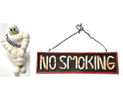 A Michelin Man Plastic Advertising Figure, printed copyright 2003, seated on a white metal bracket, 43cm high; and A Vintage 