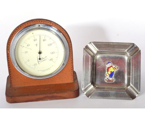 A Dunlop Leather Cased Showroom Desk Barometer, made for Dunlop Products, promotion by Rotofirm London; and A Staybrite Plate