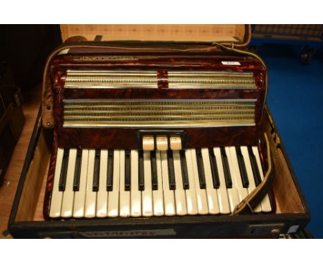A vintage Worldmaster Piano accordion, with case