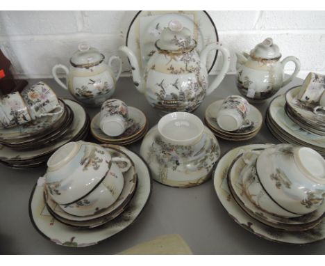 A part tea / coffee service in egg shell china hand painted with enamel detailing 35 pieces approx