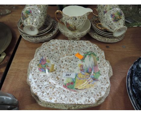 A part transfer print tea service with country garden decoration