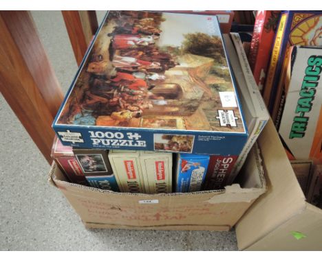 A box of jigsaw puzzles and vintage games
