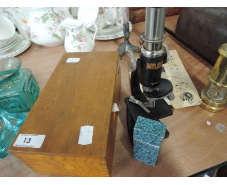 A vintage Milbro microscope with original box and slide set. 