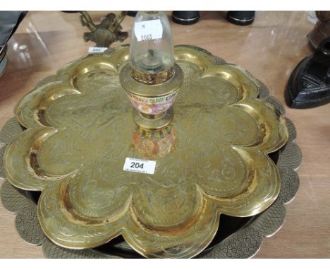 Two brass trays and a small brass oil lamp with enamel decoration