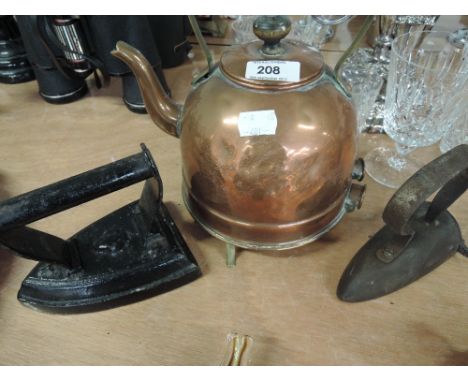 A vintage copper kettle and two flat irons