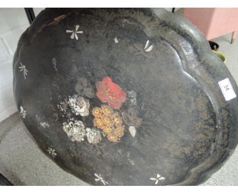 A Victorian papier mache tilt table top, hand painted floral scene with mother of pearl inlay