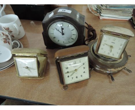 A selection of vintage mantle desk and travel clocks including smith bakelite, Safari alarm, Tempora, Coral