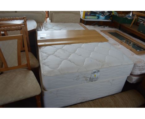 A bed and mattress with headboard