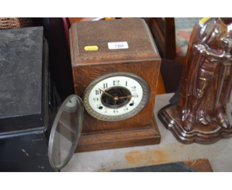 An oak cased two hole mantel clock 
