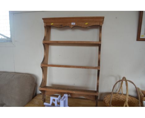 A stripped pine wall shelf 