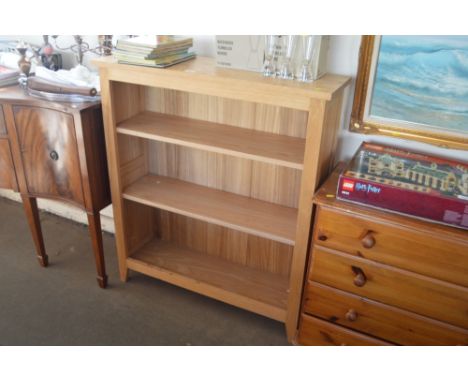 A light oak open fronted bookcase