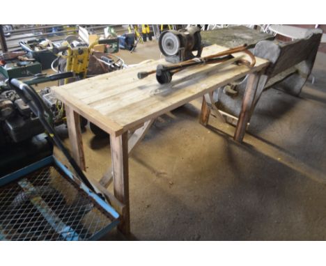 A wooden work bench with attached bench grinder lacking power lead