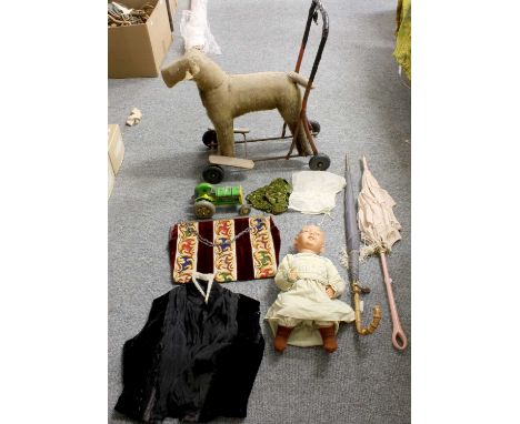 A Collection of Assorted Textiles, including: a child's push along toy dog, two parasols, tin plate tractor, enamelled tea se