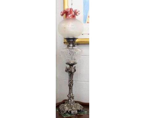 A Victorian Oil Lamp with Silver Plated Pedestal, adorned with acanthus scrolls and having cut glass reservoir, with ecthed c
