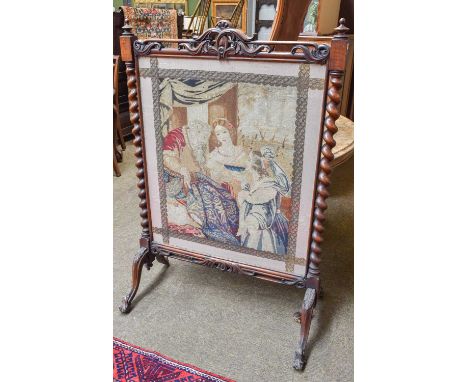 A Victorian Mahogany Firescreen,  of Country House proportions, with needlework panel between barley twist supports and on ac