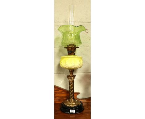 A Victorian Brass-Based Oil Lamp, with opaque green/yellow glass reservoir and etched shadeShade with minute nibbles to lower