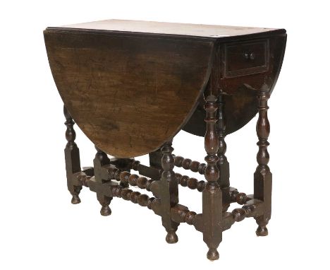 A Late 17th Century Oak Gateleg Dining Table, with two rounded drop leaves above a single drawer, on baluster turned legs joi