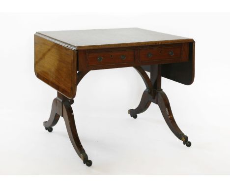 A late George III mahogany and rosewood crossbanded sofa table,with two real and two faux cock-beaded frieze drawers above re