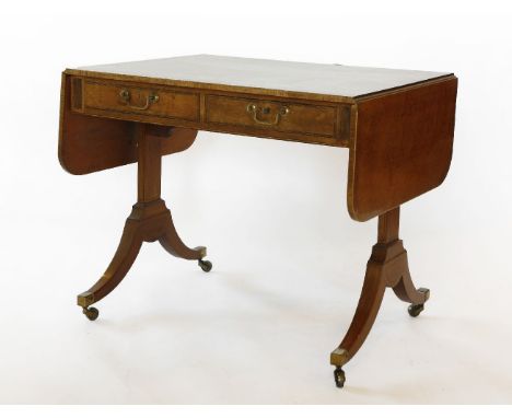 A Regency mahogany sofa table,the drop-leaf top with 'plum pudding' veneer and broad crossbanding over opposing frieze drawer