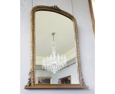 A giltwood overmantel mirror,in the 19th century style, with a ribbon finial above a decorative leaf border,106cm wide121cm h