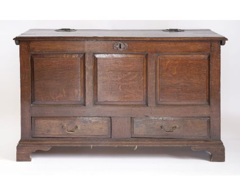 An oak mule chest,18th century, the hinged panelled top over three fielded panels, two drawers and bracket feet,136cm wide57c