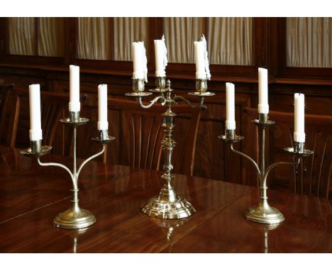 A pair of slender turned and wrought brass, two-branch, three-light table candelabra, c.1900, on circular feet, 27cm, anda pa