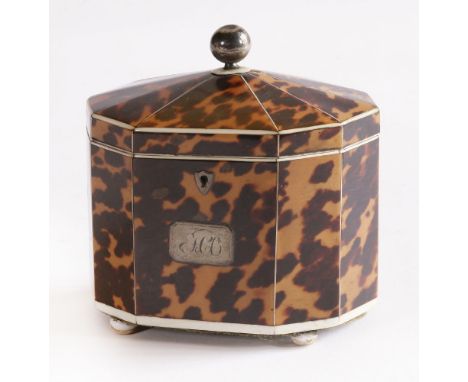 A George III tortoiseshell decagonal tea caddy,the interior with twin compartments, ivory borders and stringing, a white meta