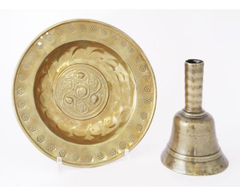 A pressed brass alms dish,probably late 17th century,21cm diameter, anda brass table bell/candlestick,probably 17th century,1