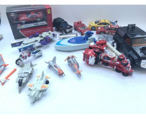 A Box Containing A Collection of Vintage Transformers. A R/c Ferrari. Terrorhawks. And 2 Loose Scalextric Cars.