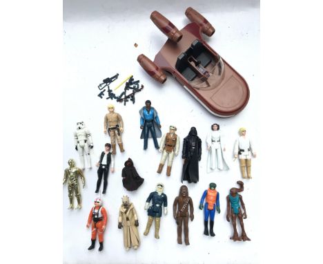 A Collection of Vintage Star Was Figures, including guns and A Land Speeder.