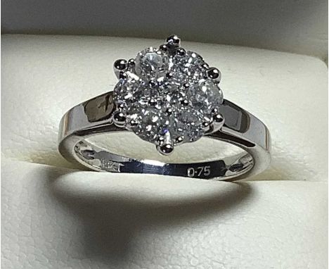 18KT WHITE GOLD SEVEN STONE DIAMOND CLUSTER RING, of flowerhead design, the round cut stones measuring 0.75cts overall approx