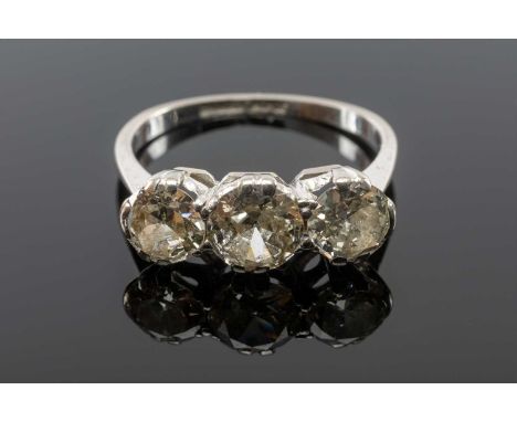 THREE-STONE DIAMOND RING, shank stamped '18CT PLAT', tot diamond wt. approx. 1.75ct, gross wt appr. 3.1gmsProvenance: private
