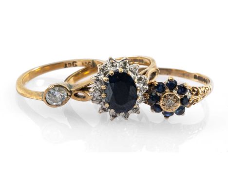 GOLD RINGS comprising two 9ct gold diamond and sapphire cluster rings, and a 9ct gold white stone ring, 5.8gms gross (3)Prove