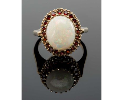 9CT GOLD OPAL & GARNET HALO RING, the large central oval opal with border of tiny garnets, ring size N, 5.3gmsProvenance: pri