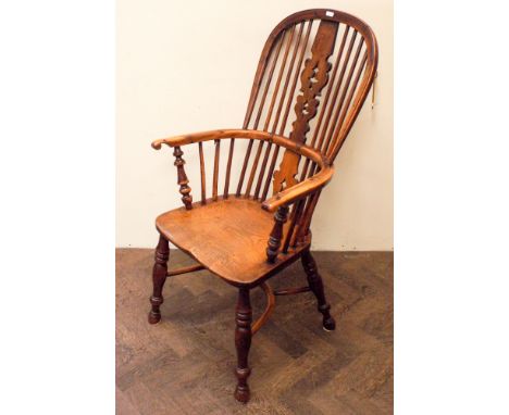 An 18th century Yew wood stick back Windsor elbow chair on hooped cross stretcher base 