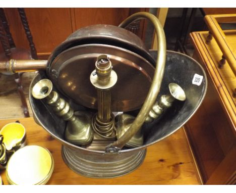 A brass coal bucket, table lamp, pair of candlesticks and a copper warming pan 